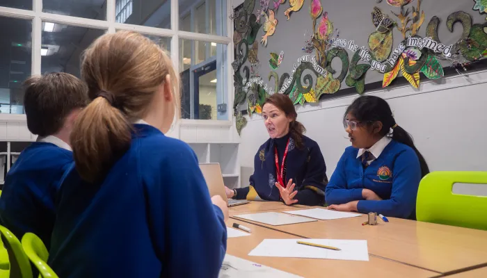 Tutor teaching primary school pupils
