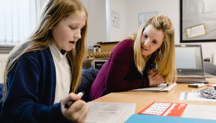 A tutor encourages a tutee in a session.