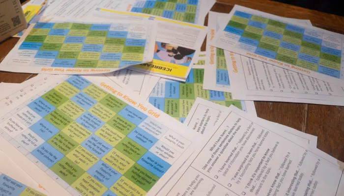 Lesson plans are laid across a table at a Tutor Trust workshop event