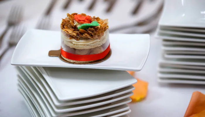 A wedding cake on a square plate.
