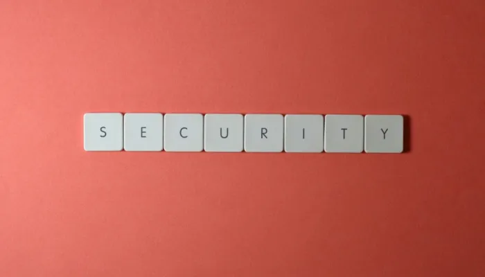 scrabble tiles spell the word security on a red background
