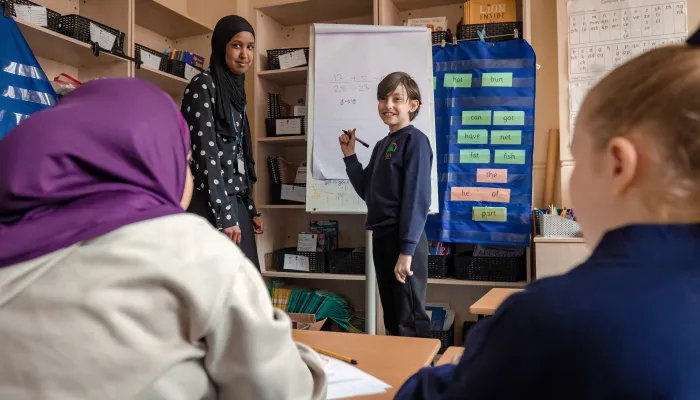 Primary school pupil teaching maths