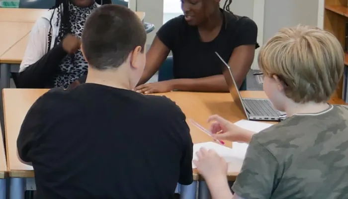 the back of two students heads, working on a school task