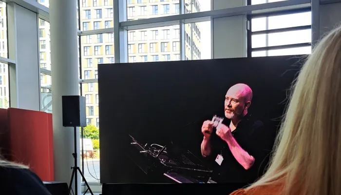 Man appears on screen giving a speech.