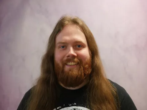 Cailum is a former Tutoring Plus tutor with us, and brings his understanding of the pupil-tutee relationship into his role as Quality Manager. He has long reddish-brown hair and a beard.