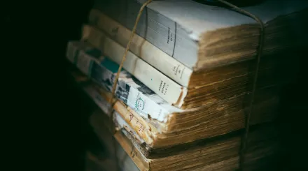 a pile of books, bound by some brown twine