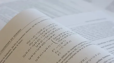 A paper report lies open on a desk.