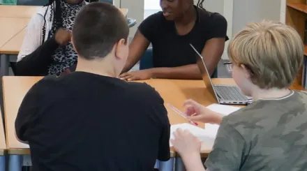 the back of two students heads, working on a school task