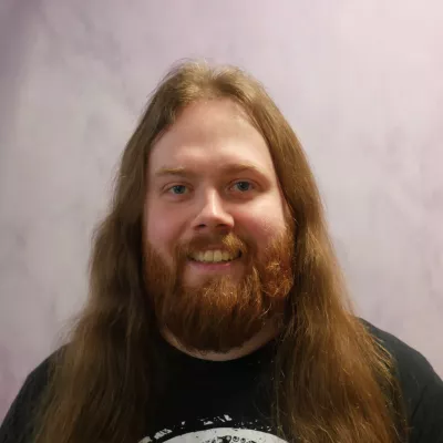 Cailum is a former Tutoring Plus tutor with us, and brings his understanding of the pupil-tutee relationship into his role as Quality Manager. He has long reddish-brown hair and a beard.