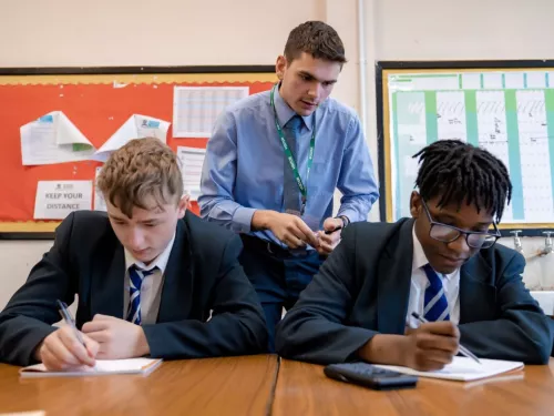 A tutor works with two pupils in a Maths session