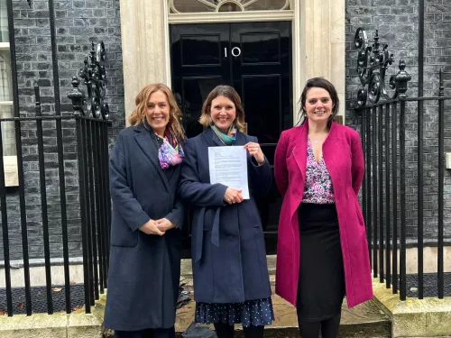 Abigail Shapiro, Susannah Hardman and Sarah Waite are pictured with the letter outside 10 Downing Street