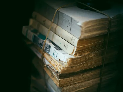 a pile of books, bound by some brown twine