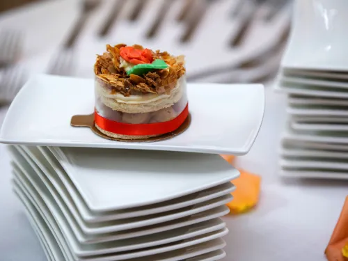 A wedding cake on a square plate.
