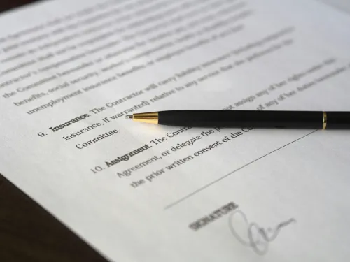 a contract with a black pen with a gold nib