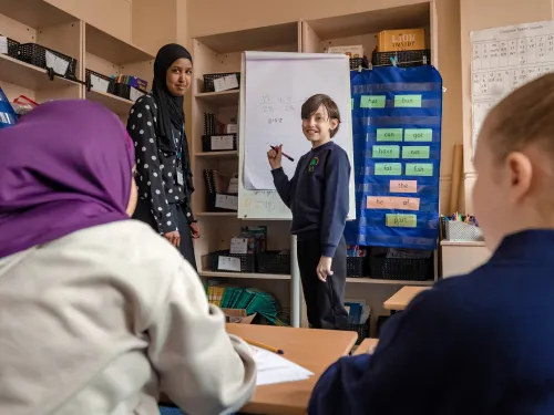 Primary school pupil teaching maths